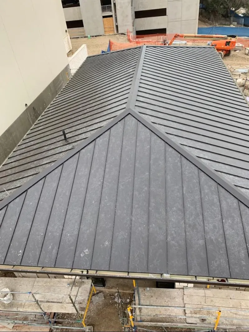 Commercial metal roof construction with crane equipment in Oshkosh