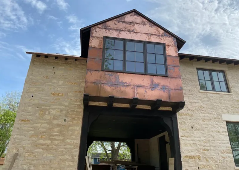 Copper metal panel facade on a stone building for Skylight Installation in Oshkosh