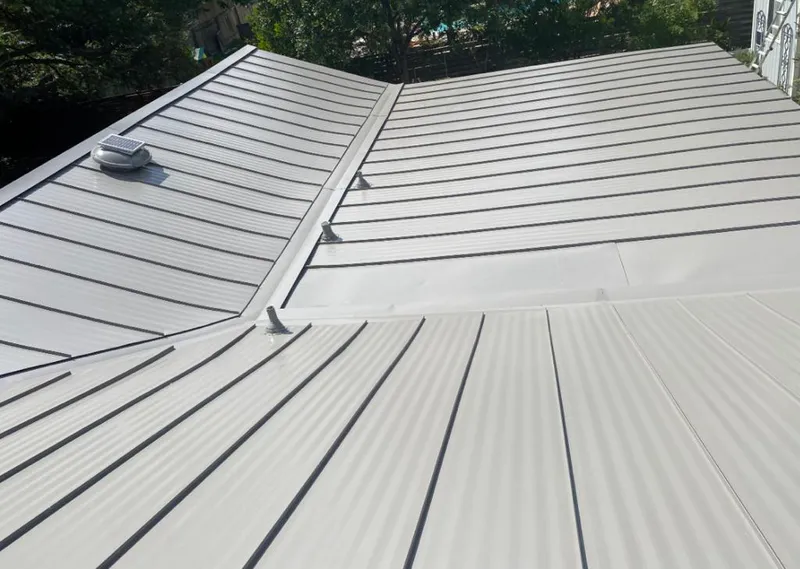 Solar attic fan installed on a metal roof for Roof Ventilation in Oshkosh